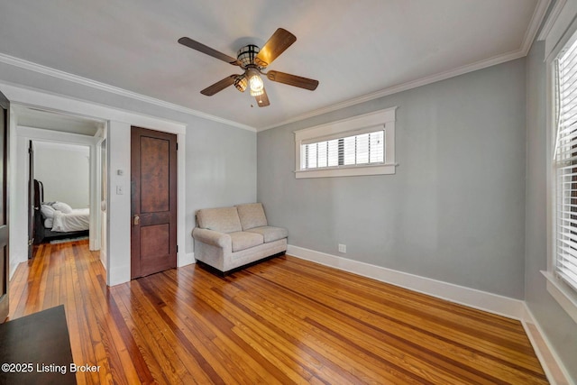 unfurnished room featuring baseboards, crown molding, light wood-style floors, and a ceiling fan