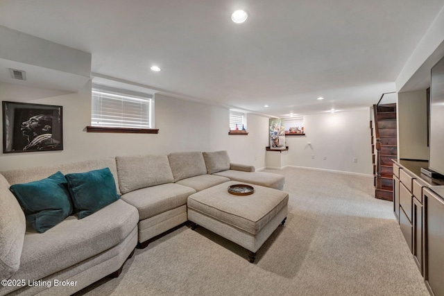 living area with recessed lighting, light colored carpet, visible vents, and baseboards