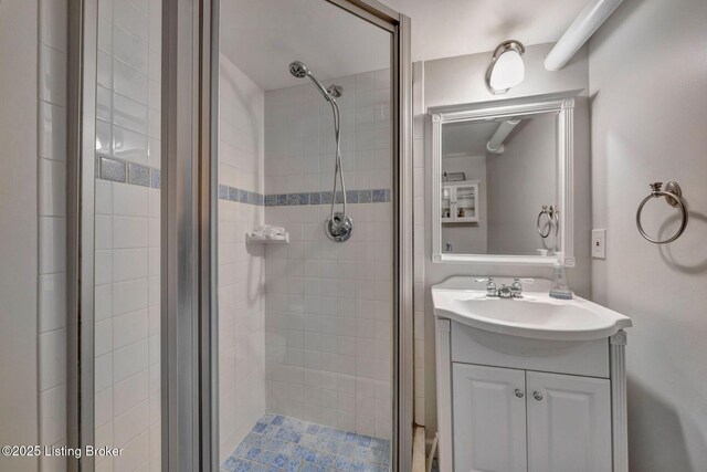 full bathroom featuring a stall shower and vanity