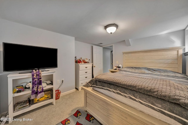 bedroom with baseboards and light carpet