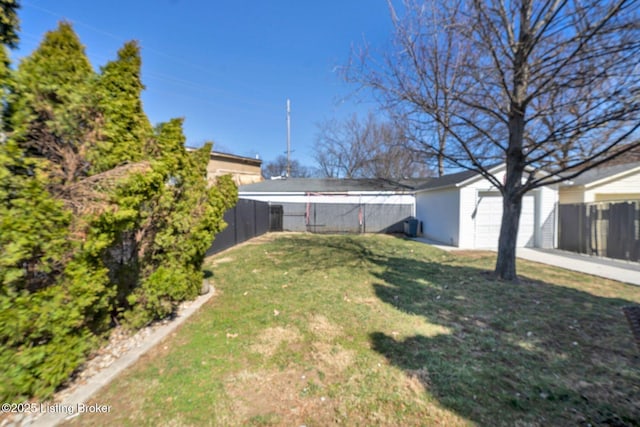 view of yard with a garage, an outdoor structure, and fence