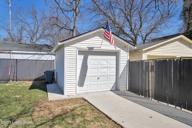 detached garage with driveway and fence