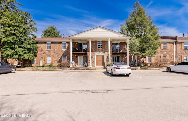 view of property featuring uncovered parking