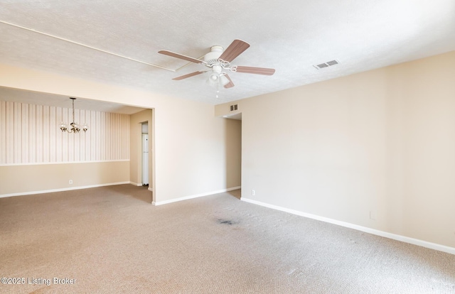 spare room featuring visible vents, baseboards, a textured ceiling, and ceiling fan