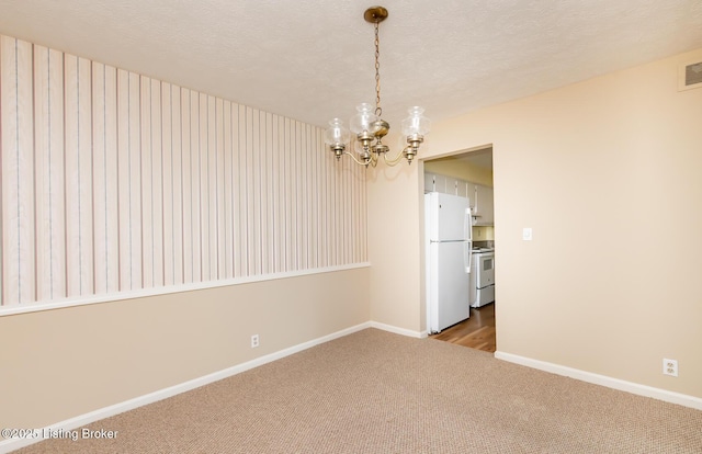 carpeted empty room with visible vents, baseboards, a textured ceiling, and an inviting chandelier