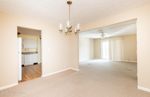 spare room with baseboards, light colored carpet, attic access, and a textured ceiling