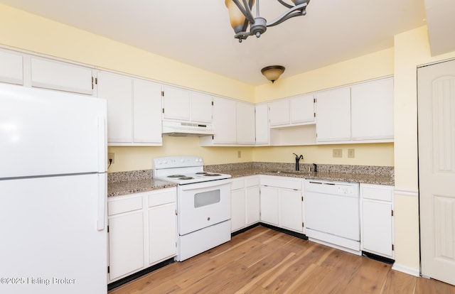 kitchen with under cabinet range hood, white appliances, white cabinetry, and a sink