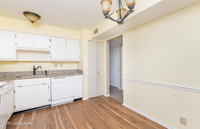 kitchen with visible vents, white dishwasher, a notable chandelier, white cabinetry, and a sink