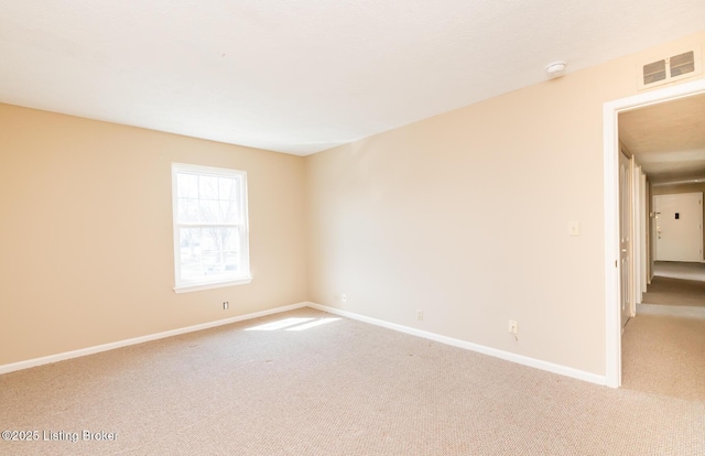 carpeted empty room with baseboards and visible vents