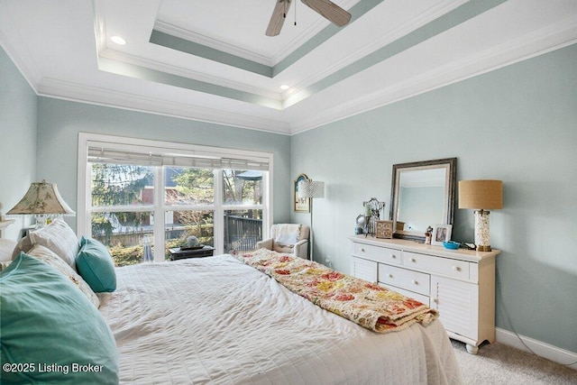 bedroom with a ceiling fan, baseboards, ornamental molding, light carpet, and a raised ceiling