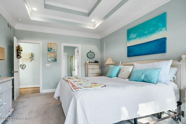 bedroom with visible vents, light carpet, ornamental molding, a tray ceiling, and baseboards