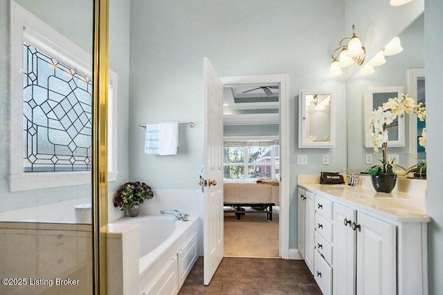 bathroom with tile patterned floors, a garden tub, ensuite bath, and vanity