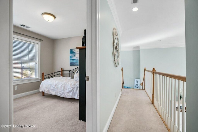 hall featuring visible vents, carpet floors, baseboards, and ornamental molding