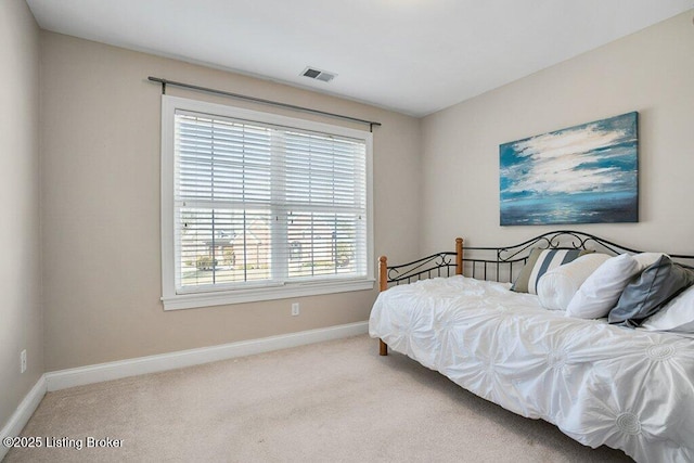 bedroom with carpet, visible vents, and baseboards