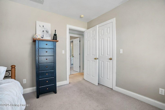 bedroom with light carpet and baseboards