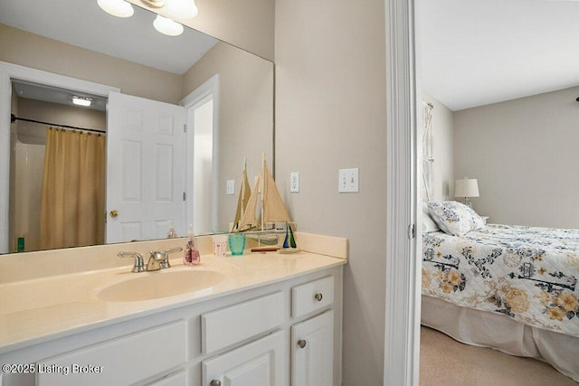 bathroom with connected bathroom and vanity