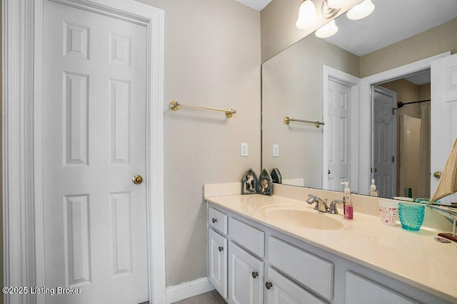 bathroom with baseboards and vanity