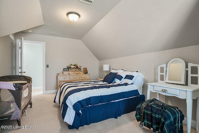 bedroom featuring vaulted ceiling, light colored carpet, visible vents, and baseboards