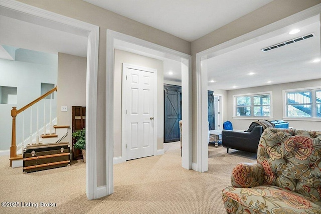 interior space featuring visible vents, carpet flooring, stairs, and baseboards