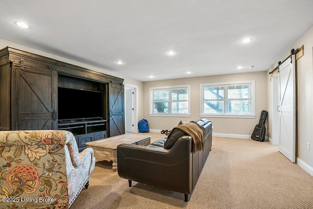 living room featuring recessed lighting, light colored carpet, baseboards, and a barn door