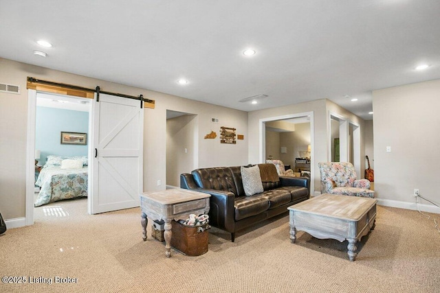 carpeted living room featuring visible vents, recessed lighting, baseboards, and a barn door