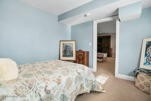 bedroom with light carpet and baseboards