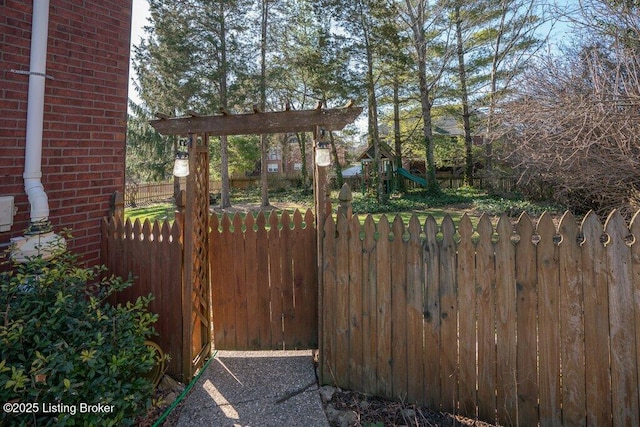 view of yard featuring a playground and fence