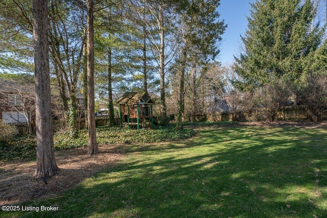 view of yard featuring fence and a playground