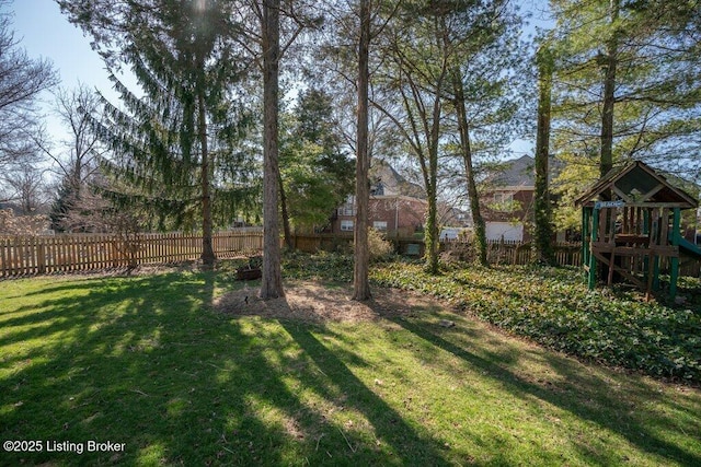 view of yard featuring a playground and fence