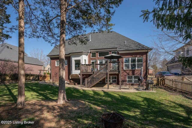 back of property featuring a lawn, a fenced backyard, stairway, a wooden deck, and a patio area