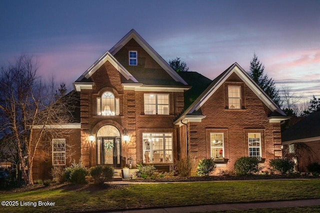 view of front facade featuring brick siding and a front lawn