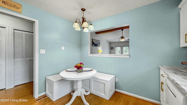 dining area featuring a notable chandelier, visible vents, light wood-type flooring, and baseboards