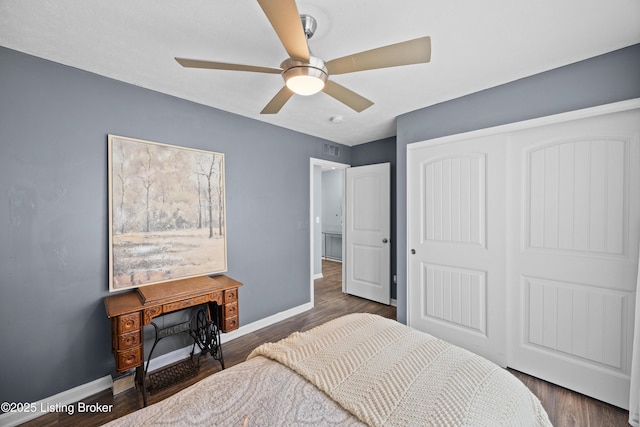 bedroom with a closet, baseboards, ceiling fan, and dark wood-style flooring