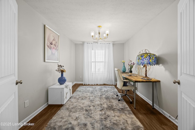 office space with baseboards, dark wood-type flooring, a chandelier, and a textured ceiling