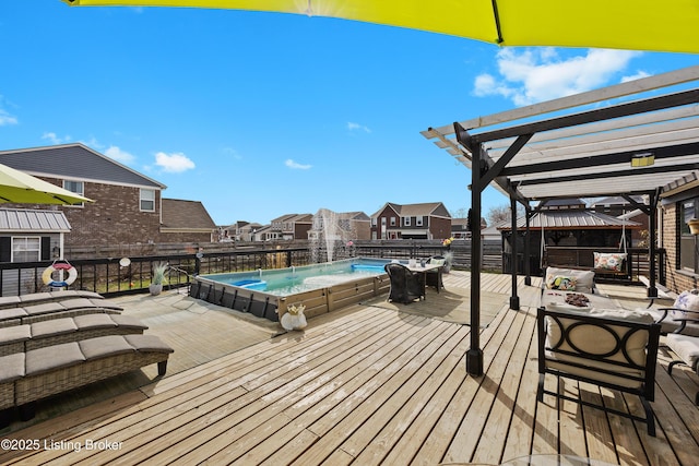 wooden deck with fence, a pergola, and a residential view