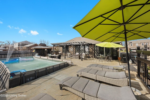 view of pool featuring a gazebo, a patio area, a fenced in pool, and fence