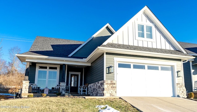 view of front of house featuring board and batten siding, concrete driveway, roof with shingles, covered porch, and an attached garage