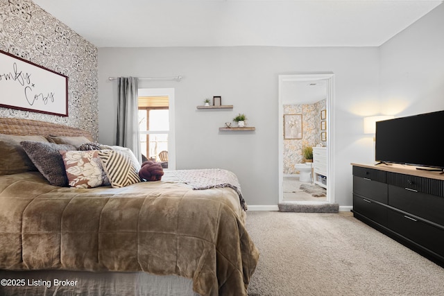 bedroom featuring connected bathroom, baseboards, and carpet