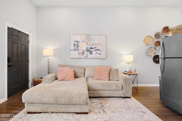 living room featuring wood finished floors and baseboards