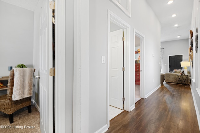 corridor featuring dark wood-style floors, recessed lighting, and baseboards