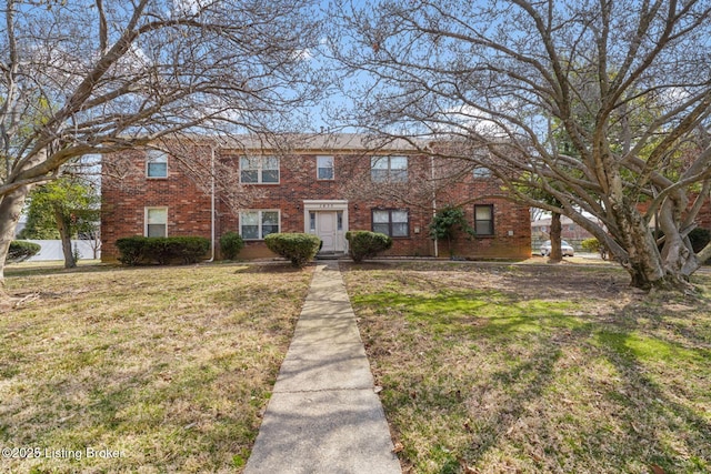 townhome / multi-family property featuring brick siding and a front yard