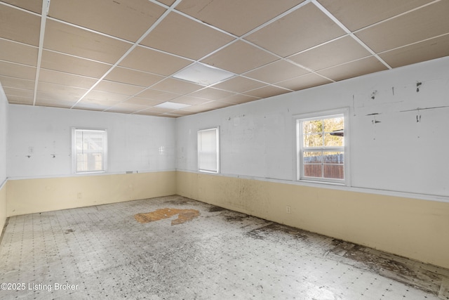 unfurnished room featuring a paneled ceiling