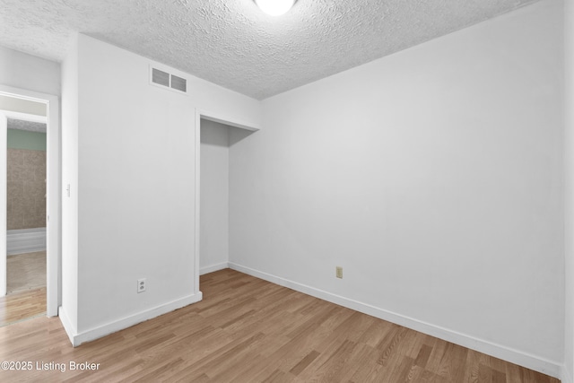 unfurnished bedroom with baseboards, visible vents, and light wood finished floors