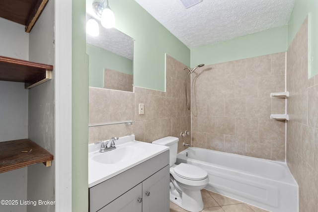 full bathroom with vanity, bathtub / shower combination, a textured ceiling, tile walls, and tile patterned floors