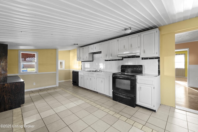 kitchen featuring black appliances, under cabinet range hood, light tile patterned flooring, white cabinets, and light countertops