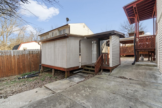 exterior space with a wooden deck and fence