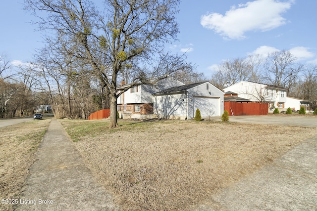 view of front of property with driveway and fence