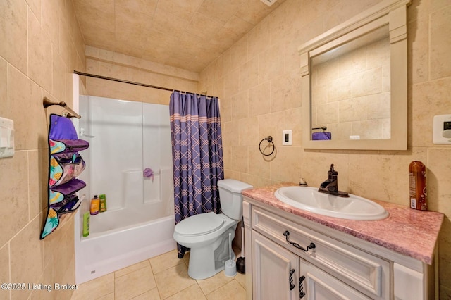 full bathroom with toilet, vanity, tile patterned floors, tile walls, and shower / bathtub combination with curtain