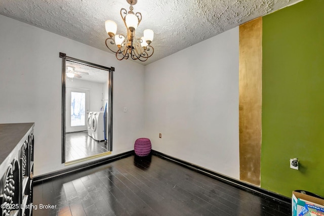 unfurnished room with hardwood / wood-style floors, a textured ceiling, a chandelier, and washer and clothes dryer