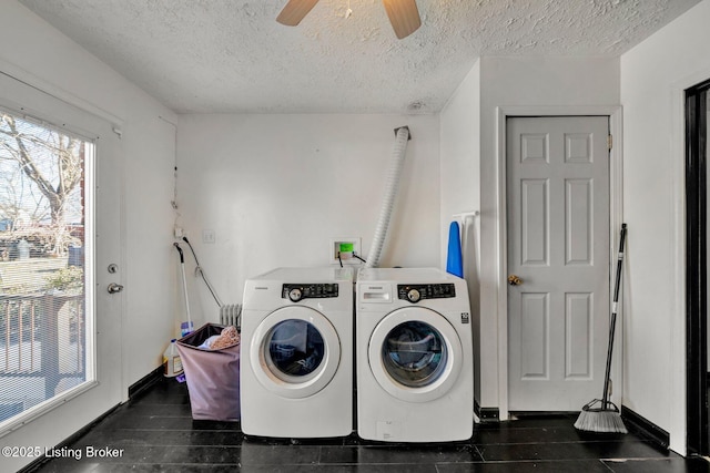 laundry area with baseboards, ceiling fan, washer and clothes dryer, laundry area, and a textured ceiling